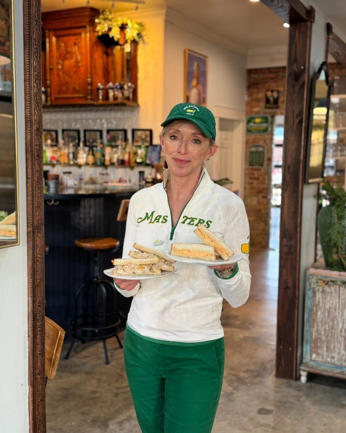 Server holding sandwiches