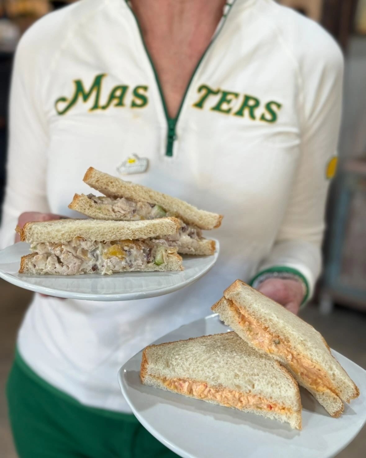 Server holding plates with chicken salad