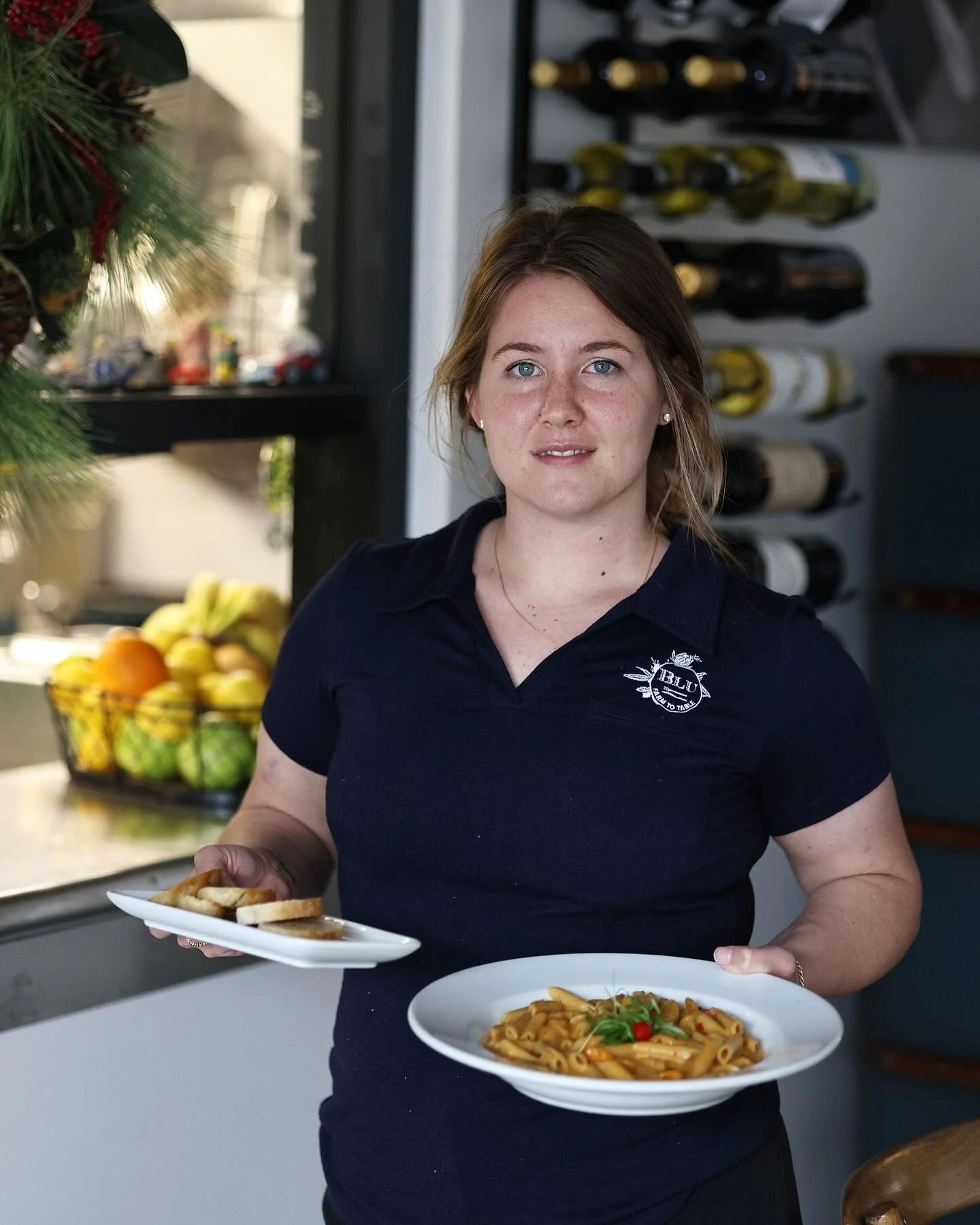 Server presenting pasta dishes